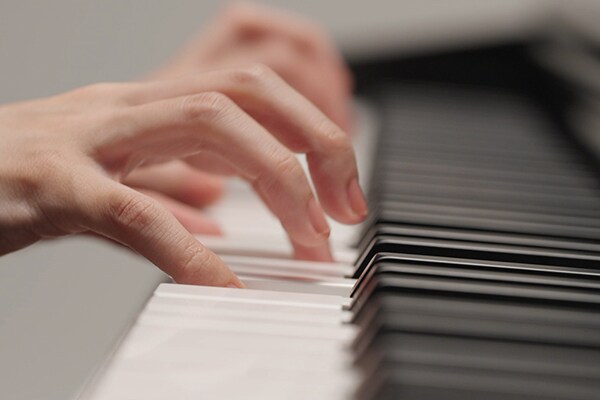 Hands playing the Graded Hammer Standard (GHS) keyboard