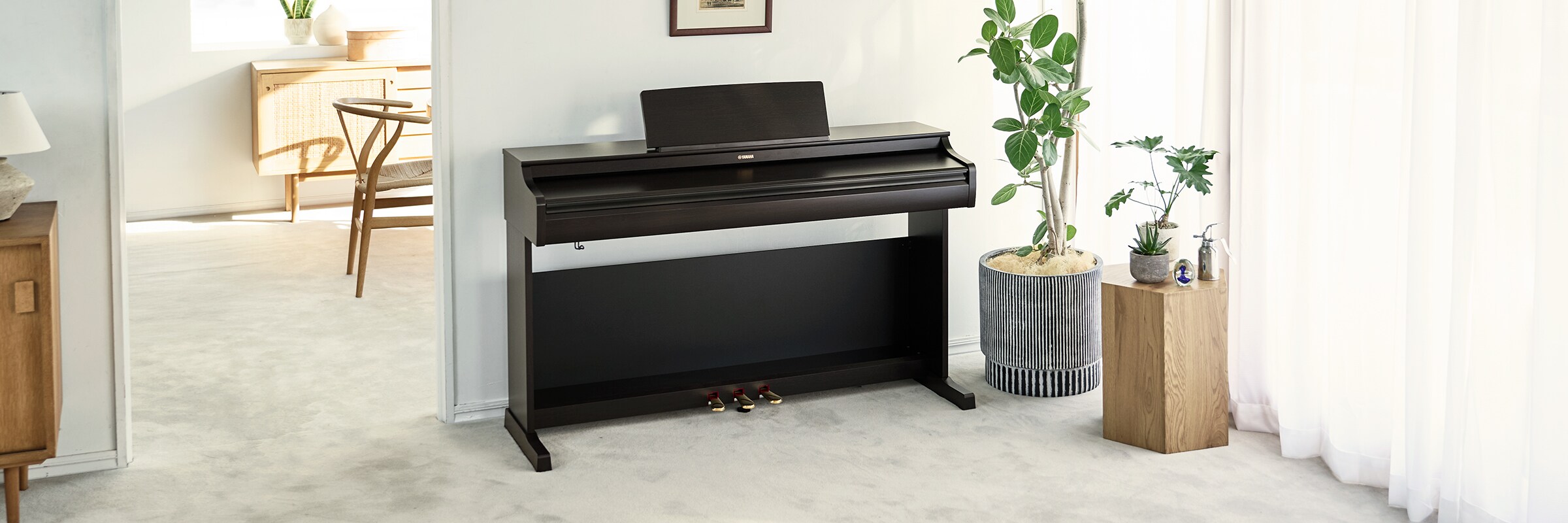 An ARIUS piano in a living room with the lid closed, blending in with the interior
