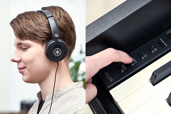 Playing an ARIUS piano with headphones and operating the control panel buttons