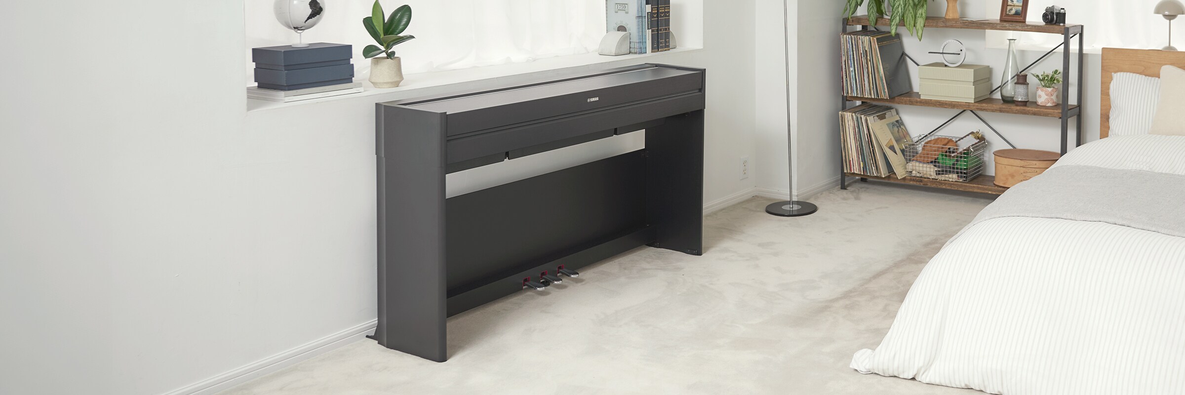 An ARIUS piano in a bedroom with the lid closed, blending in with the interior