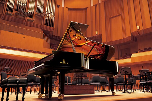Yamaha CFX concert grand piano on a concert hall stage