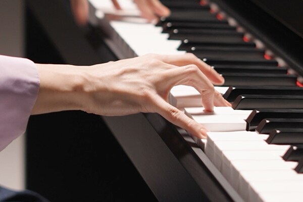 Hands playing the Graded Hammer Standard (GHS) keyboard